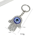 Détail du porte-clés main de Fatima avec œil bleu affichant les dimensions 117mm par 42mm - Porte-clés Main Fatima Classique