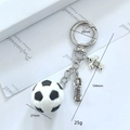 Detail of soccer keychain with 3D ball, metal cleat, and SOCCER jersey pendant charms - PVC Soft Soccer Style Four