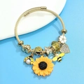 Golden wire rope bracelet featuring sunflower, bee, and daisy charms with crystal accents - Gold Cable Chain Style