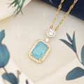 Elegant gold necklace featuring a rectangular light blue gemstone with zircon halo detail - Lips Chain (XL123) / Sea Blue Ice (Gold Tone)