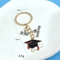 Detail of 2026 graduation keychain set with dimensions 80mm and weight 8.5g - Gold Cap And Diploma Style (2026 KC Gold Keychain)