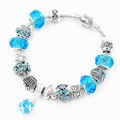 Bracciale a serpente argento con perle di cristallo azzurro e ciondolo a cuore inciso - Blu lago