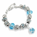 Bracciale argento con ciondoli, cristalli azzurri e perle con motivi floreali - Blu lago