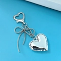 Silver metallic heart keychain with snake chain bow on vibrant blue background - Bowknot Heart 3 Heart Buckle