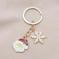 Portachiavi natalizio dorato con Babbo Natale e fiocco di neve su sfondo rosa tenue - 4#