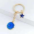 Portachiavi con stella e luna in smalto blu e anello metallico dorato per borsa - Stile Stella