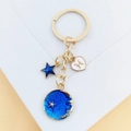Détail du porte-clés zodiaque Poissons avec pendentifs émaillés d'étoiles et lune - Poissons