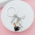Stationery sleutelhanger met passer en liniaal bedeltjes op roze achtergrond - Zwarte Penhouder Stijl