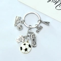 Detail of silver zinc alloy keychain with soccer charms, sports shoes, and a jersey pendant - Soccer Letters Style