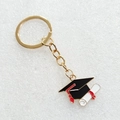 Portachiavi laurea dorato con tocco in smalto nero e nappa rossa per decorazione zaino - Stile Ciondolo Tocco Singolo