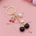 Creative cherry keychain with black and red fruit charms, white pearl and golden metal chain - Solid Black Square Cherry