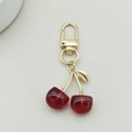 Close-up of cute acrylic red cherry keychain with gold metal lobster clasp and leaf detail - D-Clasp / Gold Leaf Red