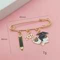 Golden 2025 graduation brooch with black pencil and graduation cap charms on pink card - 2025 Year Style 1 (2025-1#)