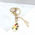 Llavero artístico dorado con colgantes de paleta y pinceles para bolsos - Figura 8 En El Tablero De Dibujo