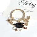 Golden 2026 graduation keychain featuring a black academic cap and diploma pendant - 2026-3#kc Gold