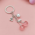 Pink translucent cherry and pearl keychain with silver metal chain on pink surface - Antique Silver Transparent Pink