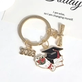 Golden graduation keychain featuring a 2023 charm, mortarboard cap, and graduate scroll - 2026-5#kc Gold