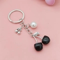 Black cherry keychain with silver metal chain and a white pearl bead ornament - Antique Silver Solid Black