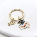 2026 graduation keychain featuring a graduation cap and book charms in gold finish - Gold Graduation Cap And Book Style (2026 Book KC Gold)