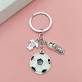 Silver soccer keychain with football, jersey and cleat charms on pink background - Antique Silver Soccer Set Style
