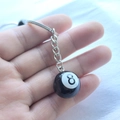 Resin black 8 ball billiards keychain with silver metal ring held in hand - Large Black 8 Ball (2CM)