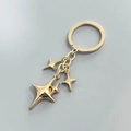 Porte-clés doré avec pendentifs étoiles à quatre branches en alliage sur anneau en métal - Pendentif Étoile Or KC (D)