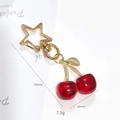 Golden cherry keychain with red transparent fruits and star-shaped clip 66mm - Red Cherry Star Hook