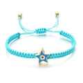 Detail of turquoise woven bracelet with a gold star pendant and blue evil eye enamel charm - Blue