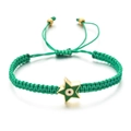 Macro detail of a green woven bracelet featuring a gold star pendant with a devil's eye - Green