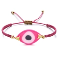 Close-up of pink woven Evil Eye bracelet with adjustable gold slider and resin charm - Pink Rope Pink Evil Eye (QQSL012-18)