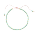 Detail of bohemian handmade beaded bracelet with blue turquoise beads and pink adjustable cord - Blue Gold With Pink Cord (QQ437)