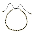 Detail of bohemian handmade beaded bracelet with black beads and gold accents on white base - Black Gold With Black Cord (QQ440)