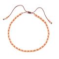 Detail of bohemian handmade beaded bracelet with orange beads and golden metallic accents - Orange Gold With Dark Reddish Brown Cord (QQ443)