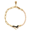 Detail of a high heel charm bracelet with pink beads and golden metal links - Pink