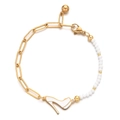 Detail of a paperclip chain bracelet with white beads and a high heel shoe pendant charm - White
