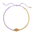 Adjustable purple beaded bracelet with gold Hamsa hand charm and woven cord - Purple