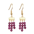 Golden drop earrings featuring tiered faceted deep purple stone beads on white background - Purple