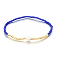 Pulsera elástica bohemia con cuentas azul marino, detalles dorados y una perla blanca - Azul