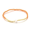 Pulsera elástica de cuentas naranjas con detalles dorados y una perla blanca - Naranja