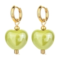 Detailed macro view of light green ceramic heart pendants on gold hoop earrings - Bright Green
