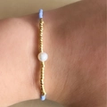 Adjustable light blue Miyuki bead bracelet featuring a single white pearl accent - Aqua