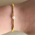 Adjustable Miyuki bead bracelet with single pearl and golden accents on wrist - Yellow