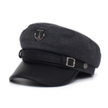 Close-up detail of grey wool texture and black PU leather brim with metal anchor emblem - Gray
