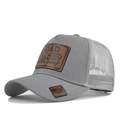 Close-up of gray mesh trucker hat with leather patch and USA map embroidery - Light Gray