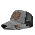 Detail of grey mesh trucker hat with brown leather patch and embossed DAD text - Marl Grey