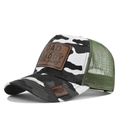 Detail of truck hat with camo pattern, mesh back, and brown leather dad slogan patch - White Camouflage