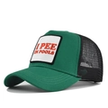 Detail of embroidered I PEE IN POOLS patch on a green and black mesh trucker hat - Adjustable / Green