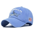 Detail of shark embroidery and American flag patch on washed blue cotton baseball cap - Adjustable / Blue
