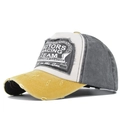 Dettaglio cappellino vintage lavato con toppa Motors Racing Team e bordi consumati a mano - Giallo + Nero
