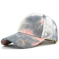 Detail view of tie-dye baseball cap featuring yellow contrast stitching and gray pink colors - Grey Tie Dye